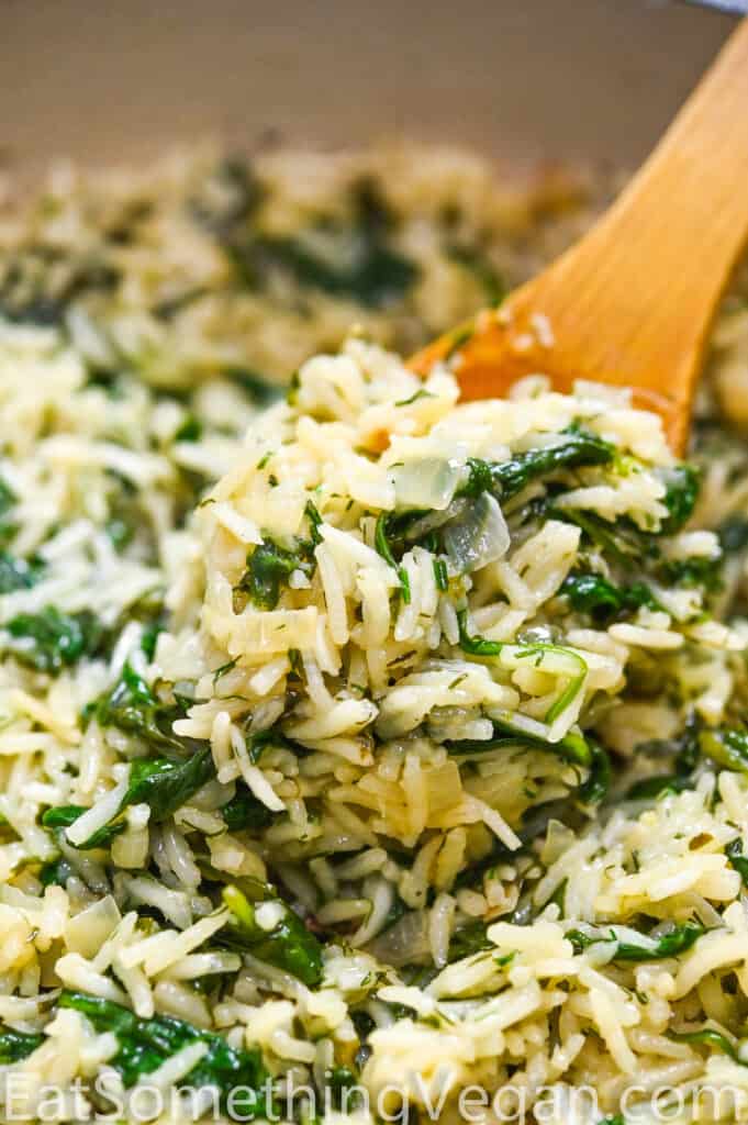 Spinach rice on a wooden spoon