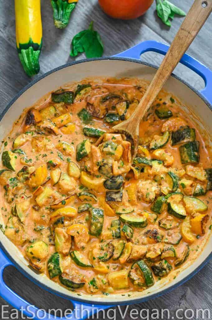 zucchini sauce in the skillet with vegetables on the backgorund