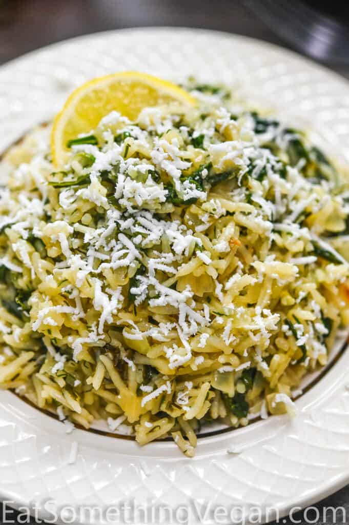 Spinach Rice in a plate topped with vegan feta cheese