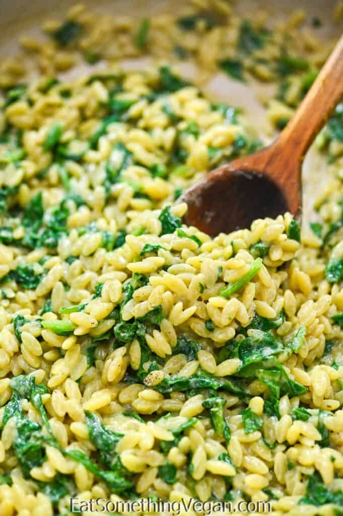 Vegan Spinach Orzo on a wooden spoon