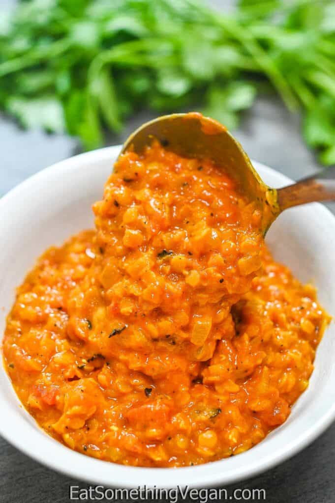 poring the Hearty Red Lentil Stew into a plate