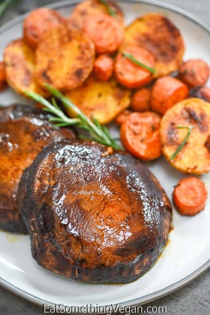 Baked Portobello Steaks on a plate with roasted vegetables