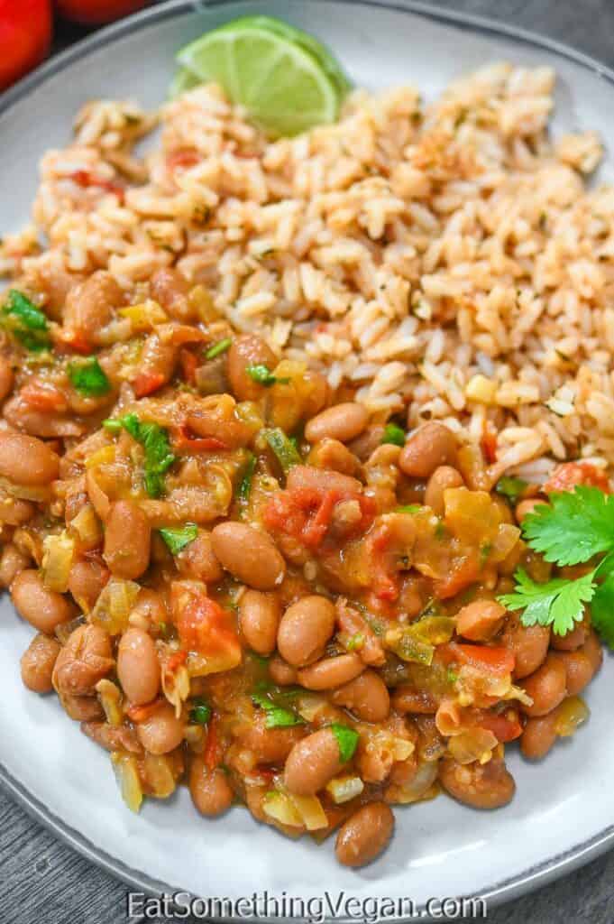 Chipotle Pinto Beans on a plate with rice on the side