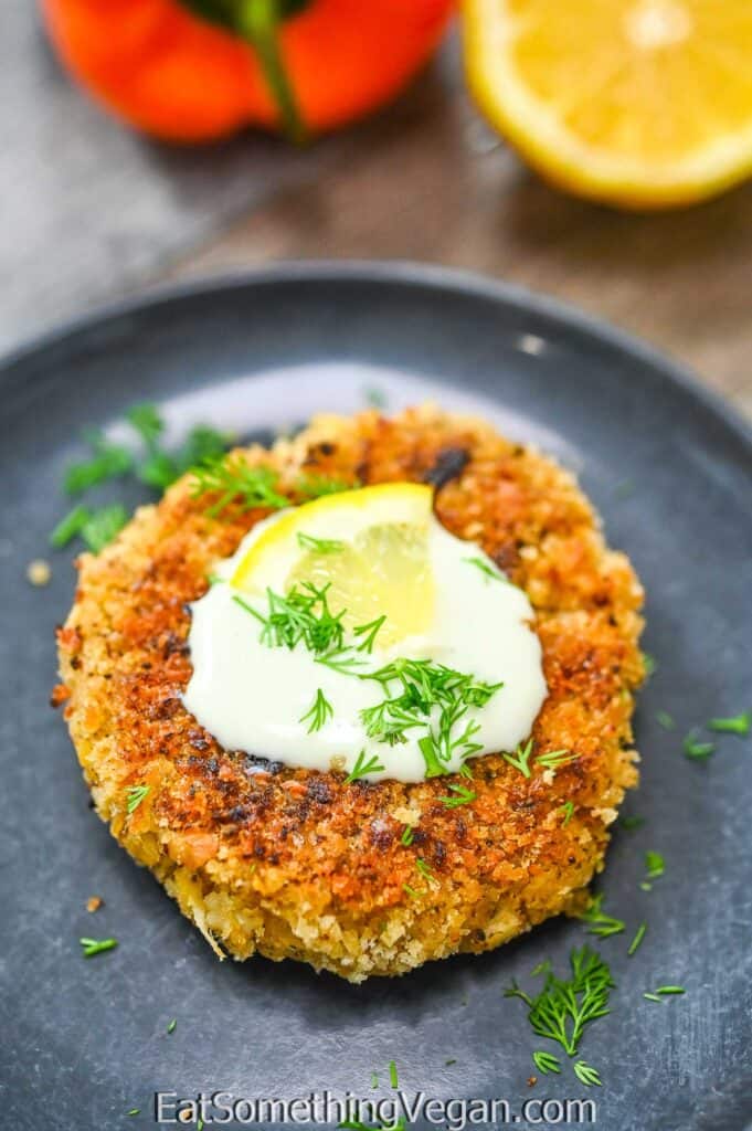 Vegan Crab Cakes on a plate topped with mayo and lemon wedge