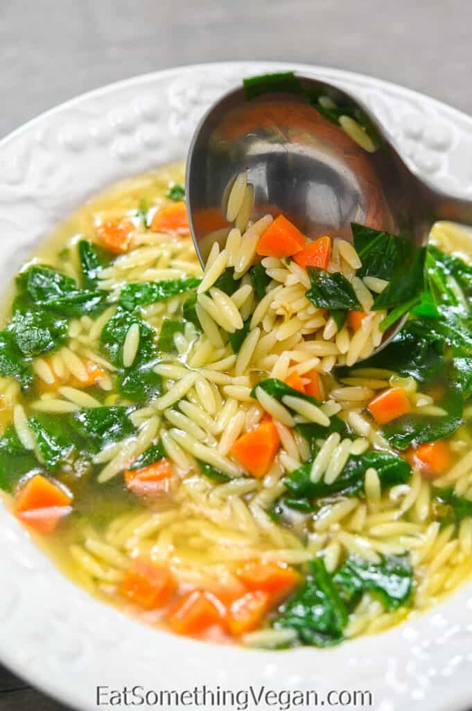 Spinach Orzo Soup on a ladle