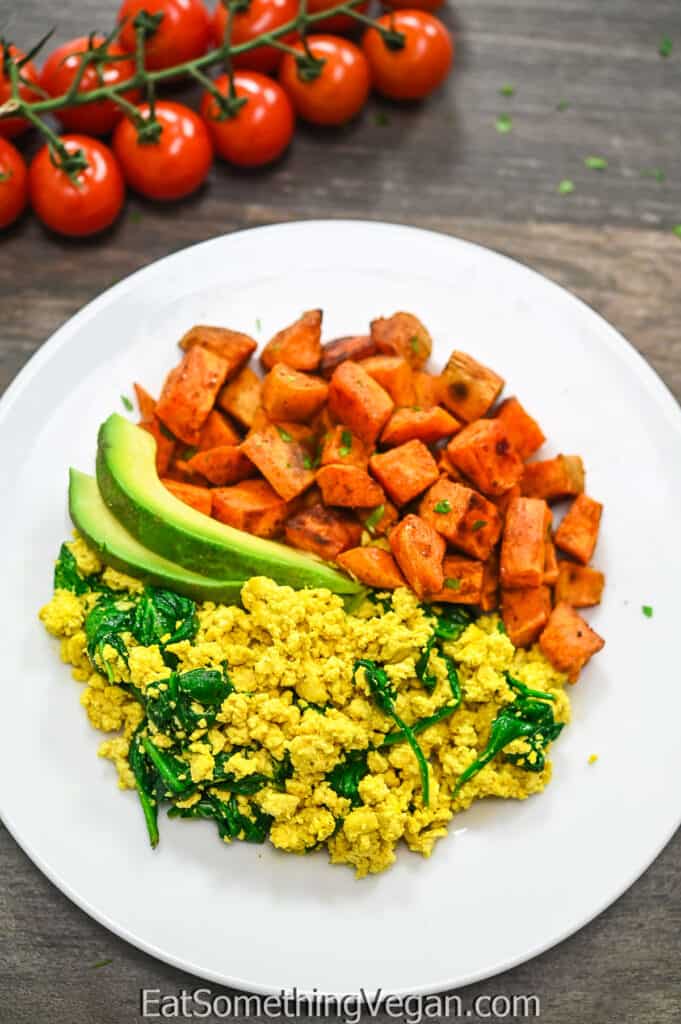 Easy Tofu Scramble on a plate with sweet potatoes on the side