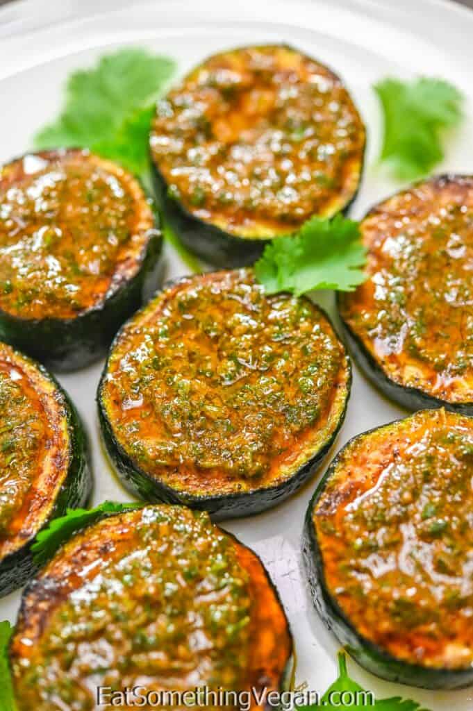 Zucchini "Steaks" with Chermoula on a white plate