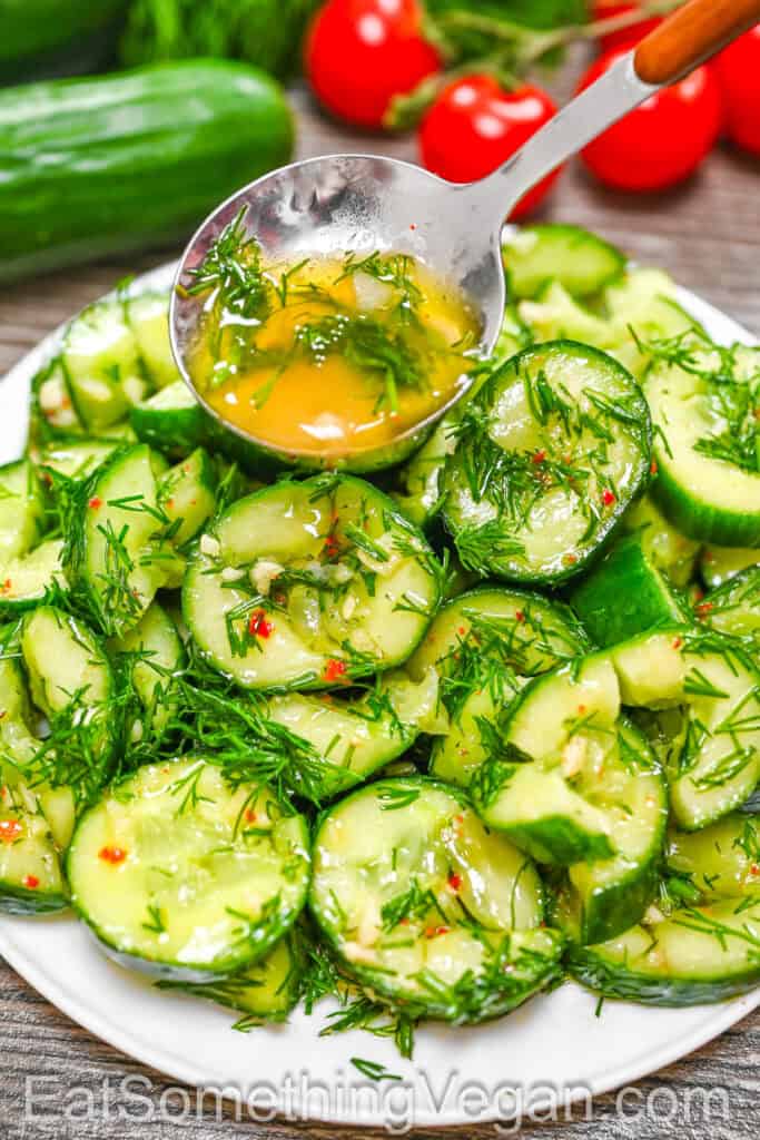 Smashed Pickled Cucumbers with a spoonful of marinade