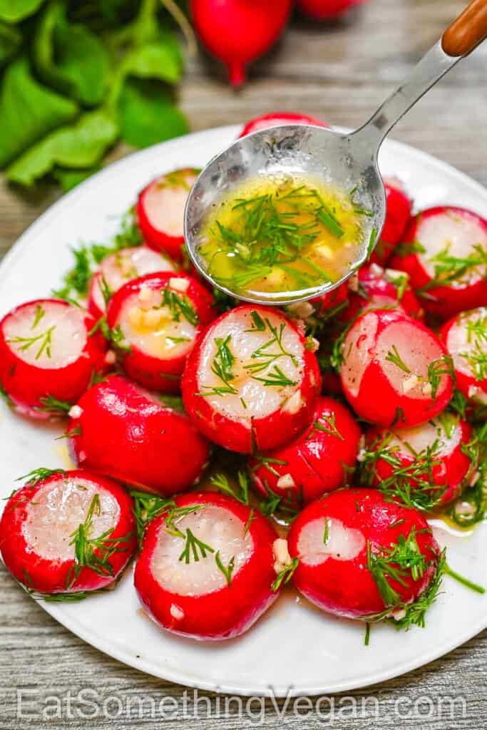 Smashed Pickled Radishes on a plate, drizzled with marinade