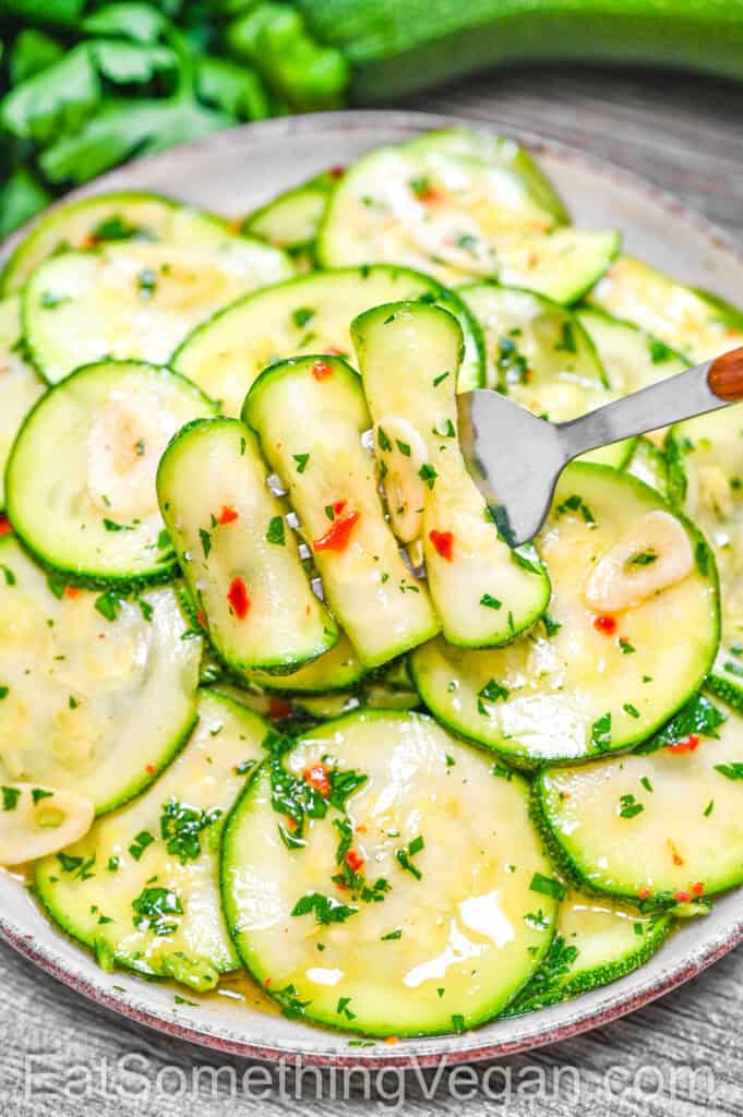 Marinated Zucchini on a fork above a plate