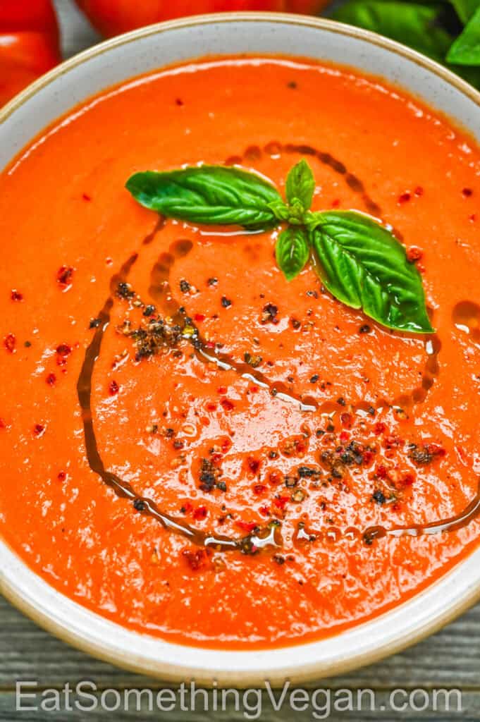 Roasted Tomato Soup in a bowl with basil and olive oil drizzle