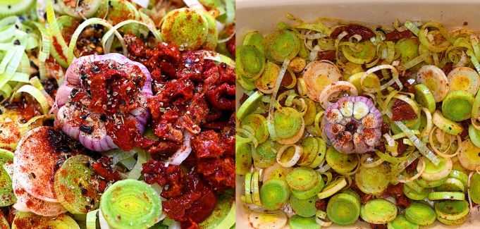 Leeks, garlic head, and sun-dried tomatoes with spices in a baking dish