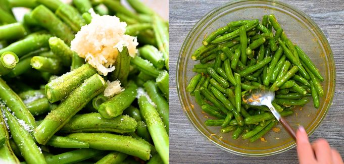 Green beans mixed with garlic, salt, and oil in a bowl