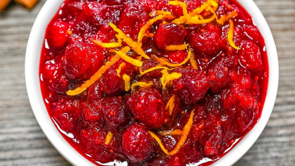 Close-up of cranberry sauce topped with fresh orange zest