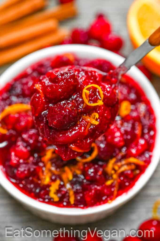 Cranberry Sauce on a spoon with orange zest