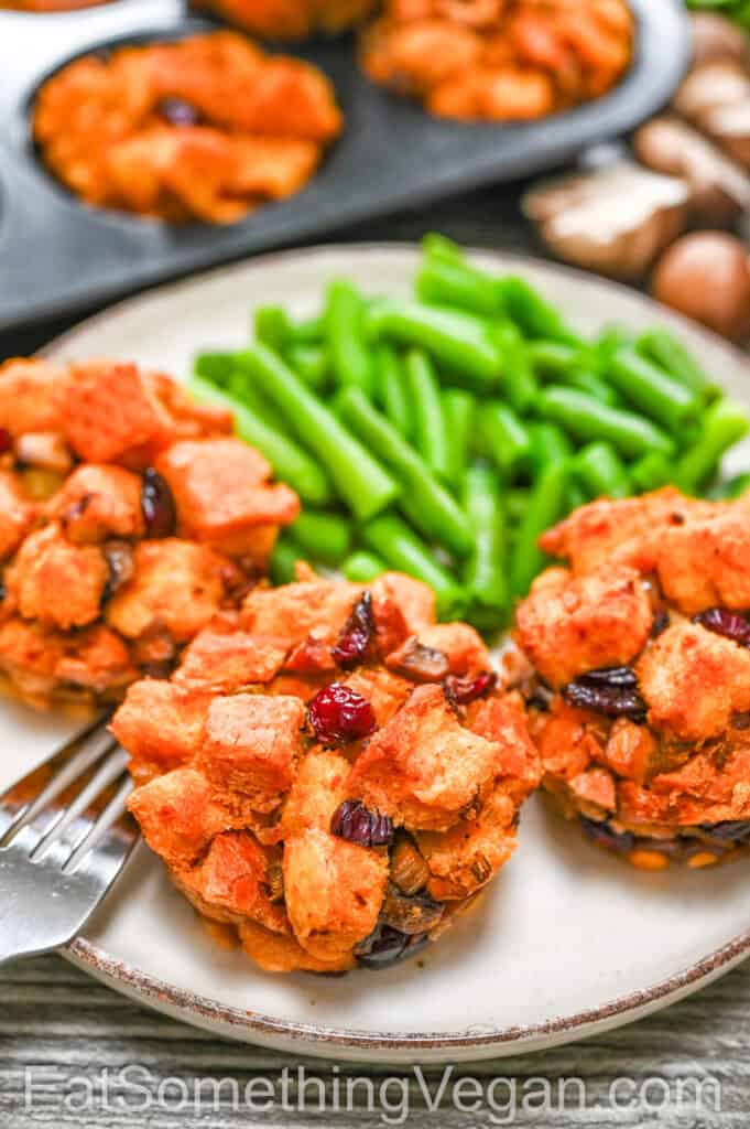 Crispy Vegan Stuffing Cups served with green beans on a plate