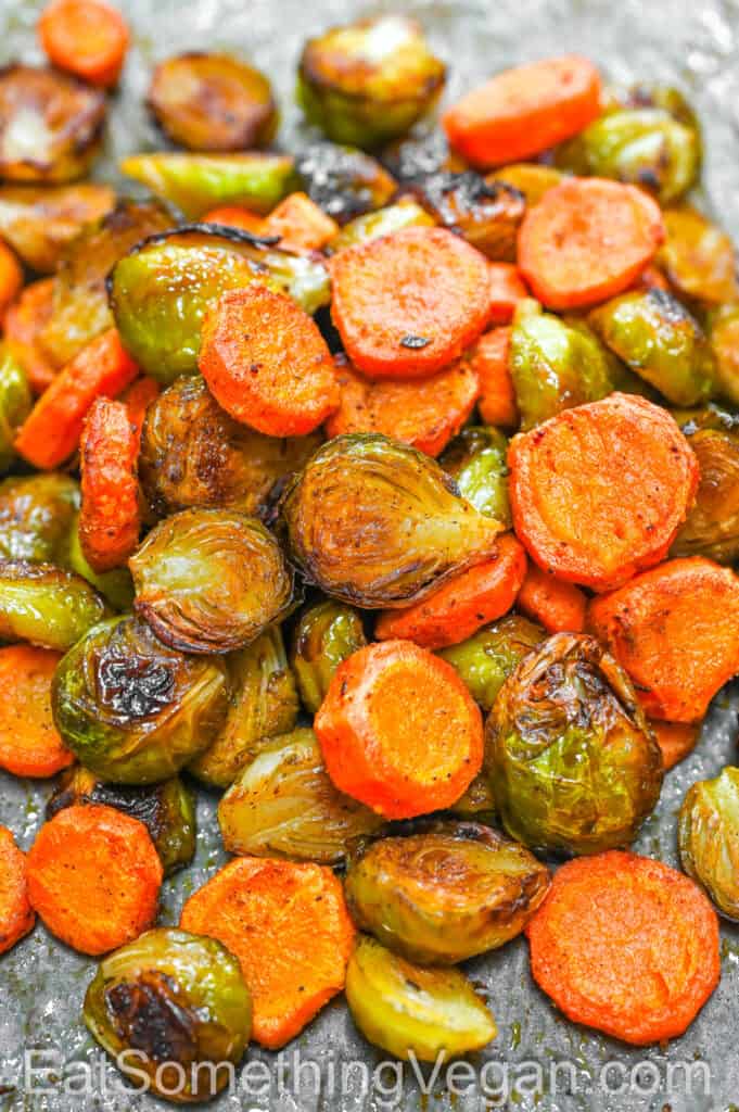 Baked Brussels Sprouts and Carrots on a baking sheet.