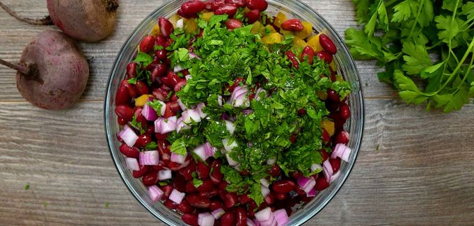 Salad ingredients in a bowl before tossing