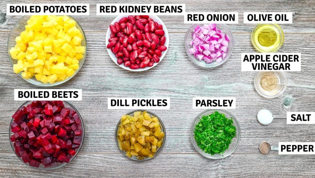 Beet and bean salad ingredients arranged on a wooden table