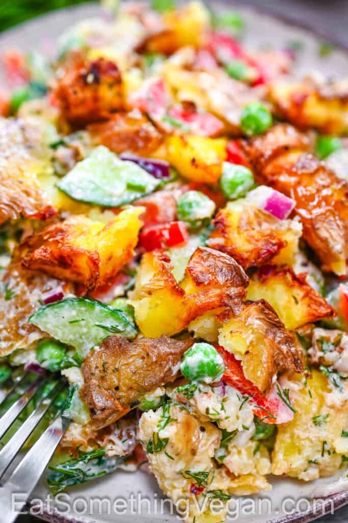 Close-up of creamy smashed potato salad with crispy roasted potatoes