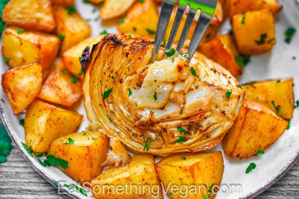 Close-up of roasted cabbage with golden roasted potatoes on a plate
