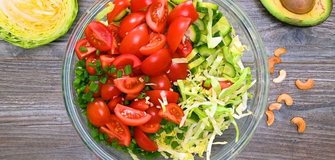 Cabbage salad ingredients in a bowl before mixing