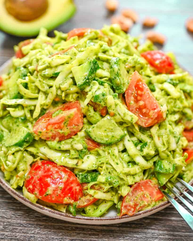 Cabbage salad with creamy avocado dressing and fresh vegetables