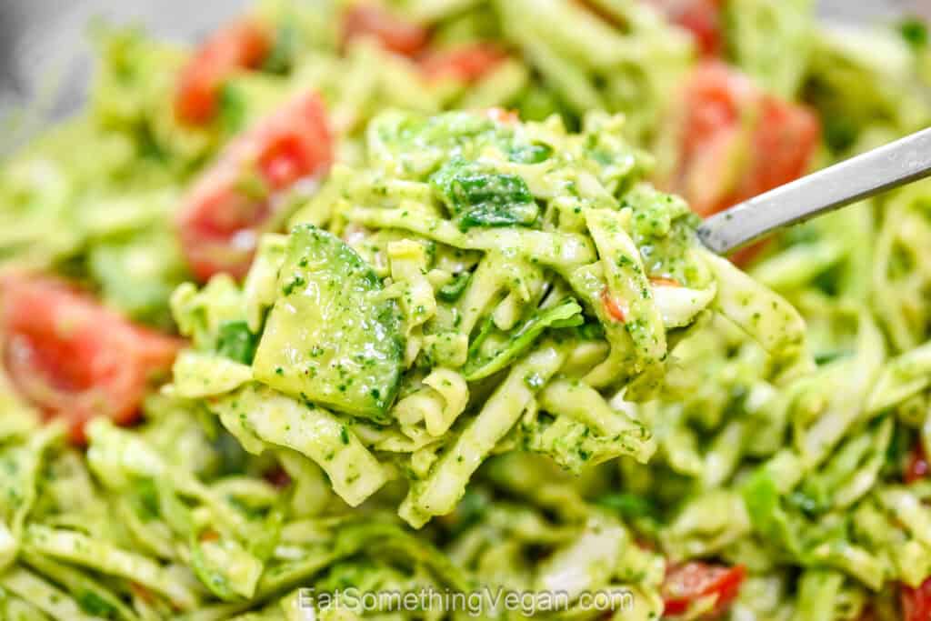 Cabbage salad with creamy avocado dressing on a fork
