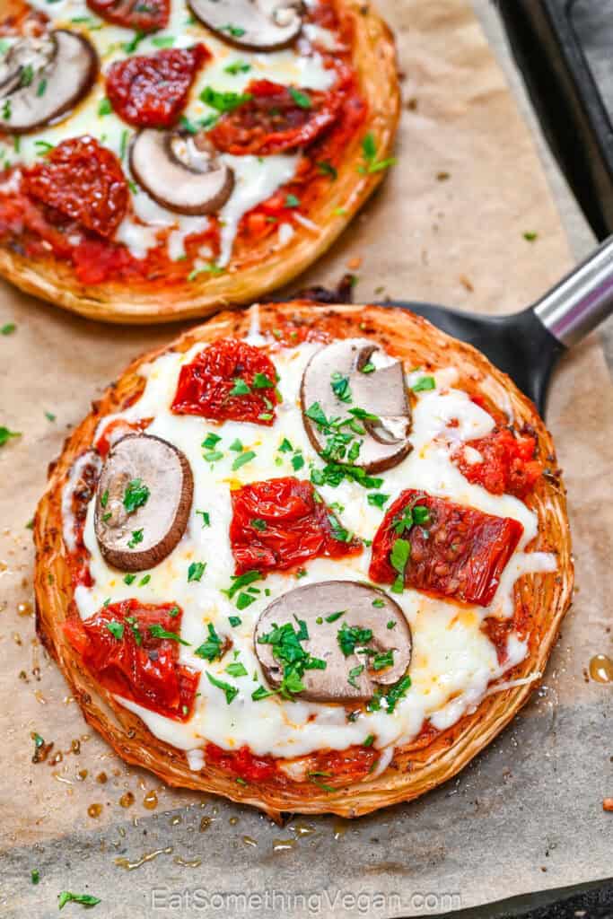 Cabbage pizza steaks on baking sheet with toppings
