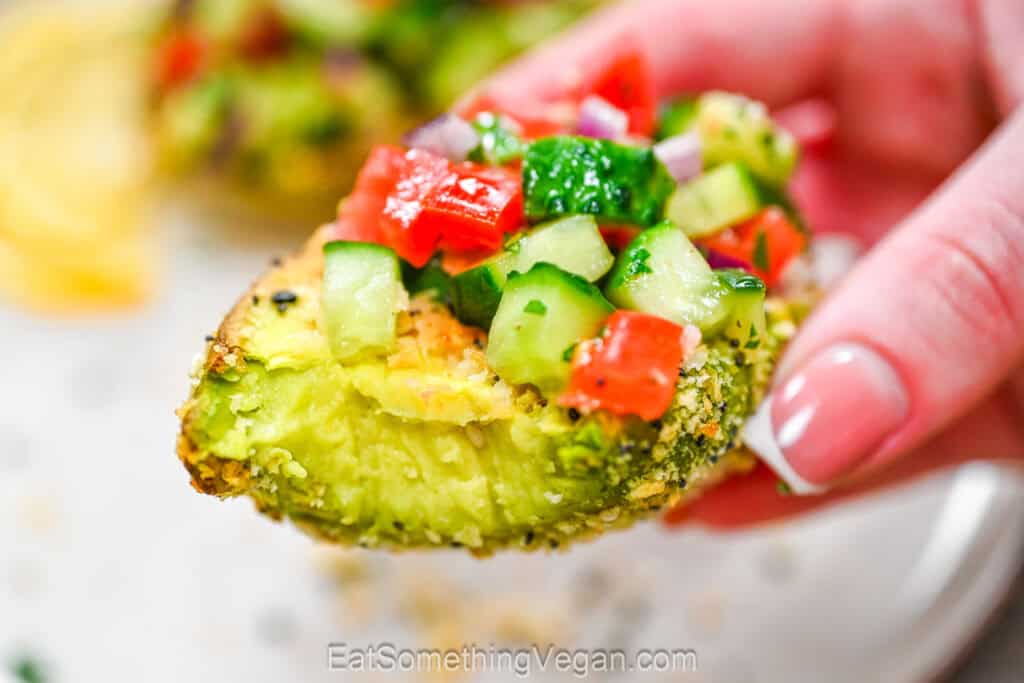 Bitten crispy avocado with cucumber tomato salad