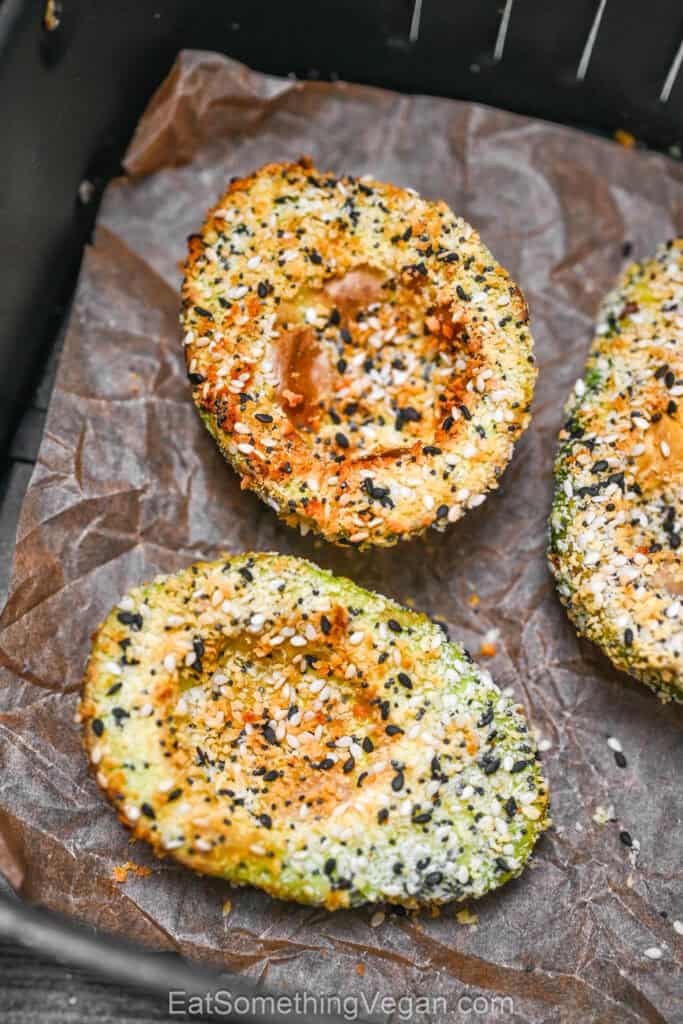 Crispy air fryer avocado halves in air fryer basket