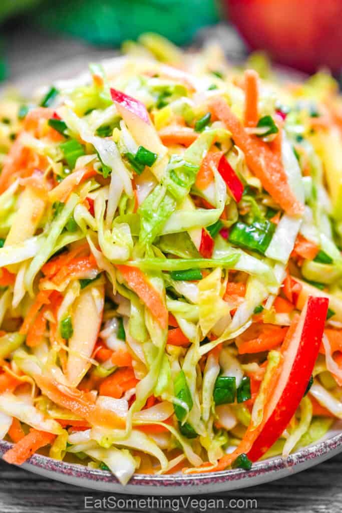 Close-up of crunchy cabbage apple salad with carrot and green onions