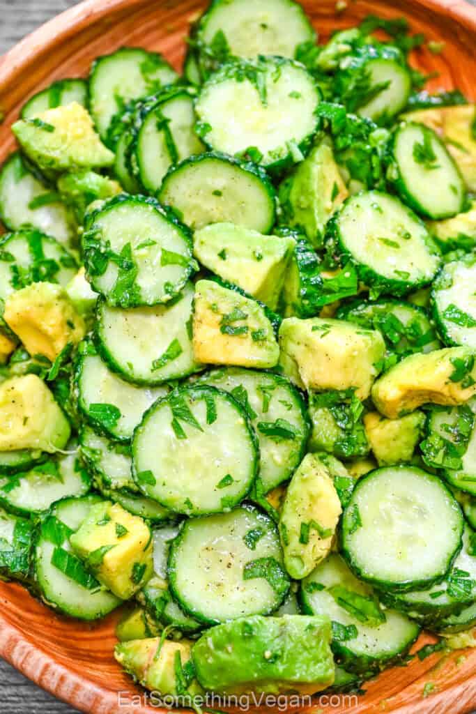 Close up of cucumber avocado salad with fresh herbs