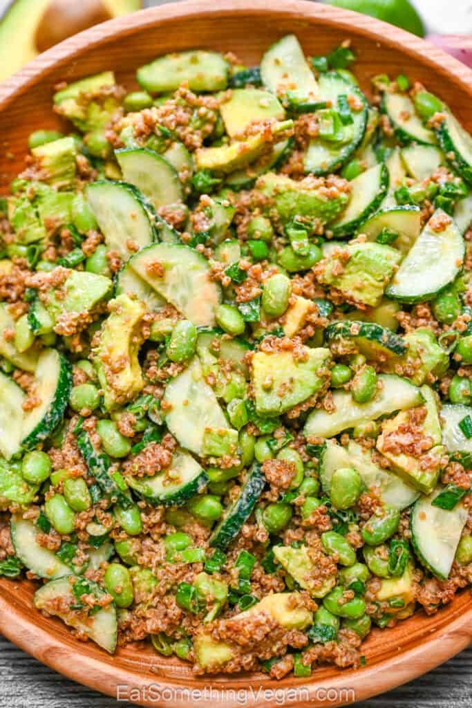 Crispy quinoa salad with peanut dressing in a bowl with avocado, cucumber, and edamame