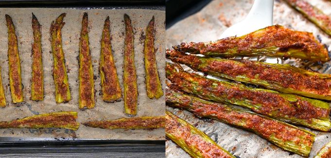 Crispy oven-roasted smashed asparagus with nutritional yeast and garlic powder being served with a white spatula on a baking sheet.