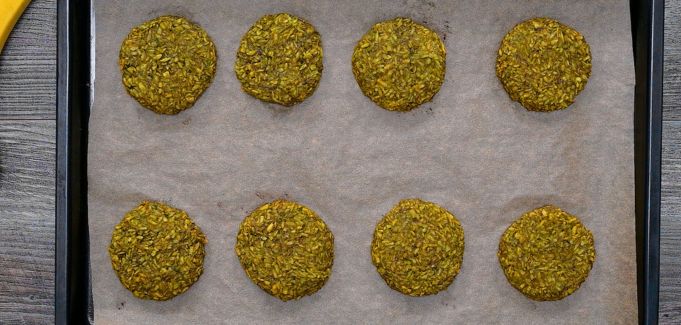 Baked vibrant green treats fresh out of the oven, arranged on a baking sheet with parchment paper.
