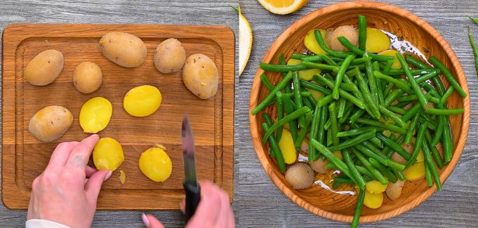 Slicing warm boiled potatoes on a cutting board and adding them to a wooden bowl with blanched green beans.