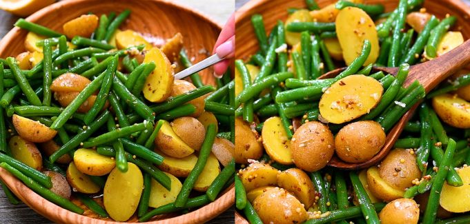Tossing the potato and green bean salad with dressing in a wooden bowl using a large spoon.