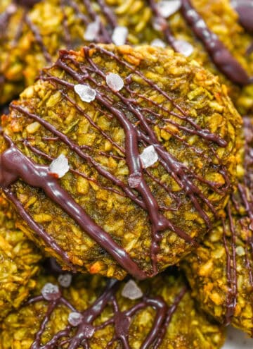 Featured image of healthy vegan matcha coconut cookies decorated with a rich dark chocolate drizzle and coarse sea salt flakes.