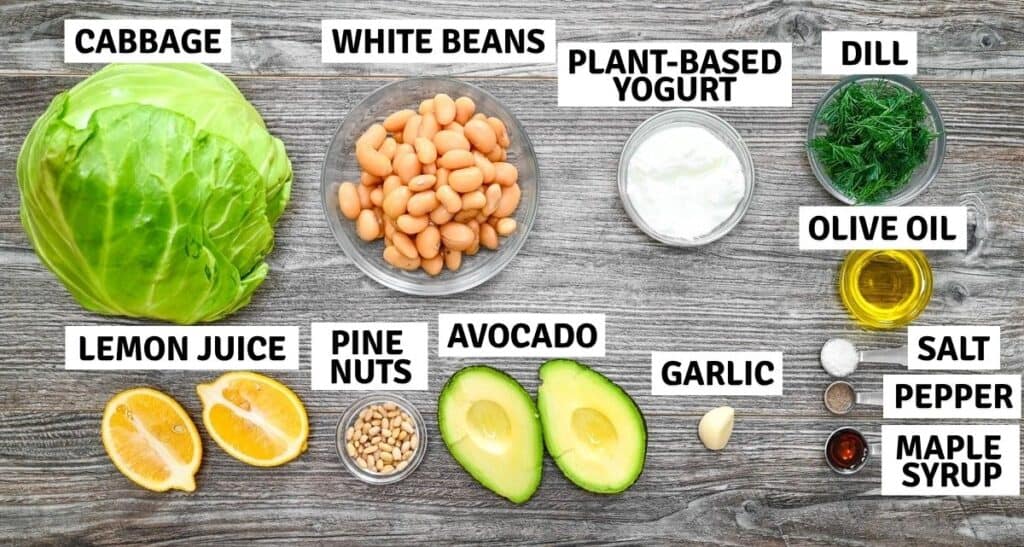 Flat lay of fresh plant-based ingredients and spices prepared for cooking on a grey surface.