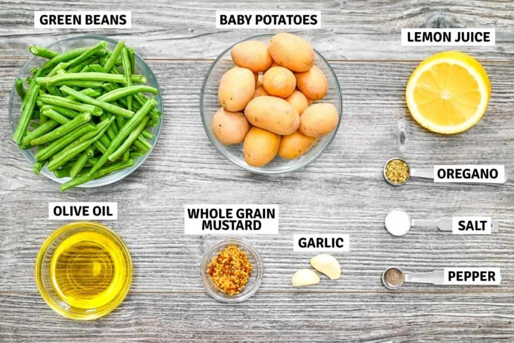 Ingredients for potato and green bean salad arranged on a table.
