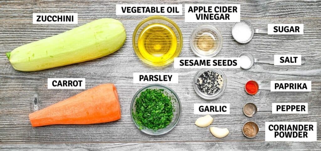 Fresh ingredients arranged on a table for a zucchini salad.