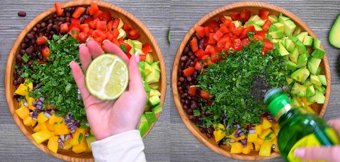Adding fresh lime juice, olive oil, salt, and black pepper to the salad ingredients in a wooden bowl.