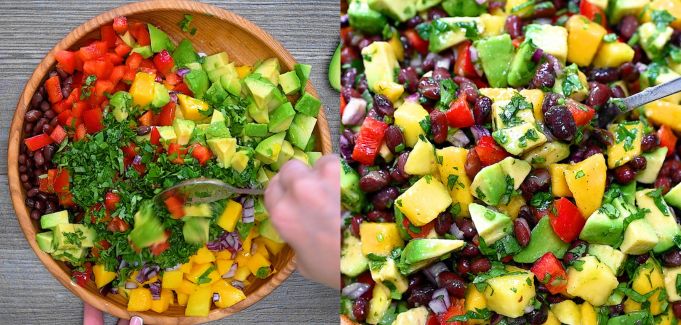 Tossing the salad in a wooden bowl.