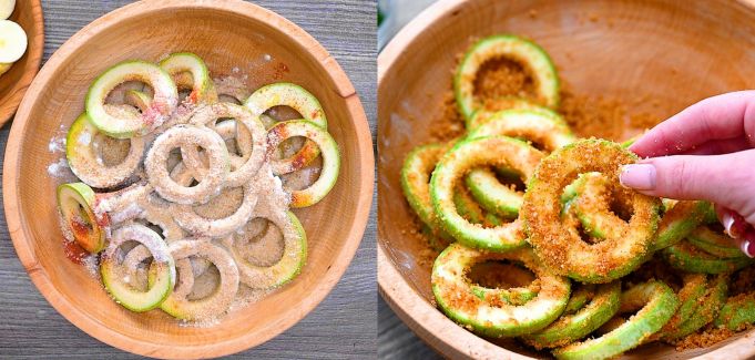 Mixing zucchini rings in a wooden bowl with spices.