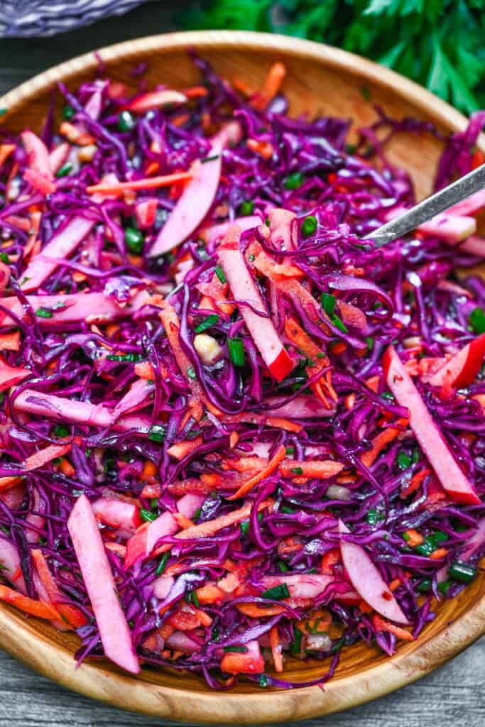 Red Cabbage Salad with Apples and Walnuts served in a wooden bowl.
