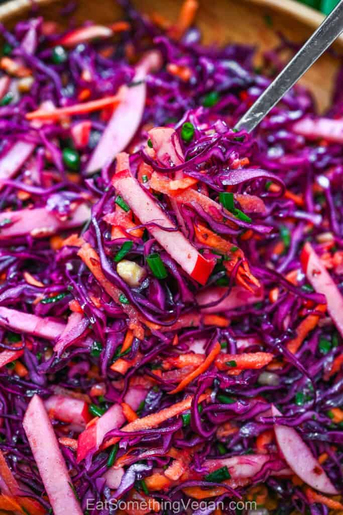Red Cabbage Salad with Apples and Walnuts close-up showing crisp shredded cabbage and apple matchsticks.