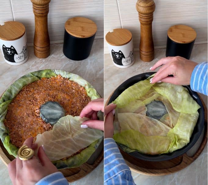 Covering the top with cabbage leaves and folding overhanging edges inward to seal the cake.
